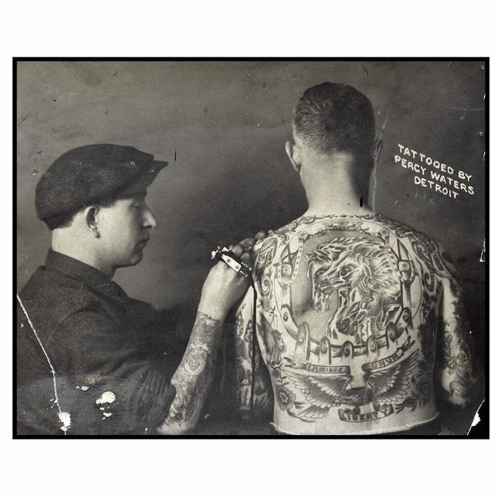 Percy Waters working on a back piece for “Dutch”, 1920 vintage tattoo historical archive photograph