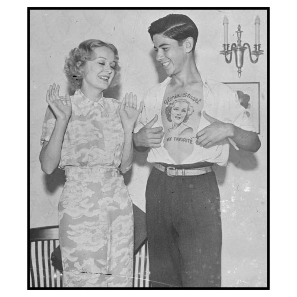 Ray Pearl shows Gloria Stuart her face tattooed on his chest that was done by his uncle, Hollywood, Los Angeles, California, September 2nd, 1937 vintage tattoo historical archive photograph