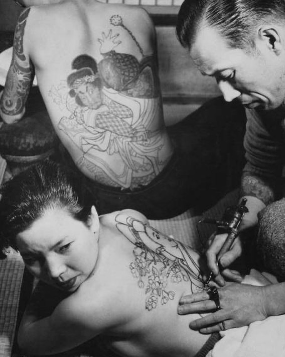 Tokumitsu Uchida (Horigorō II) working on a back piece using his self made machine, c.1955 vintage tattoo historical archive photograph