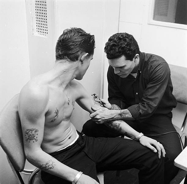 Tony D’Anessa tattooing his client, David King, c.1959 vintage tattoo historical archive photograph