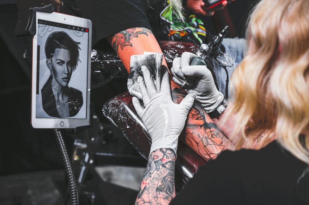 tattoo artist wearing gloves