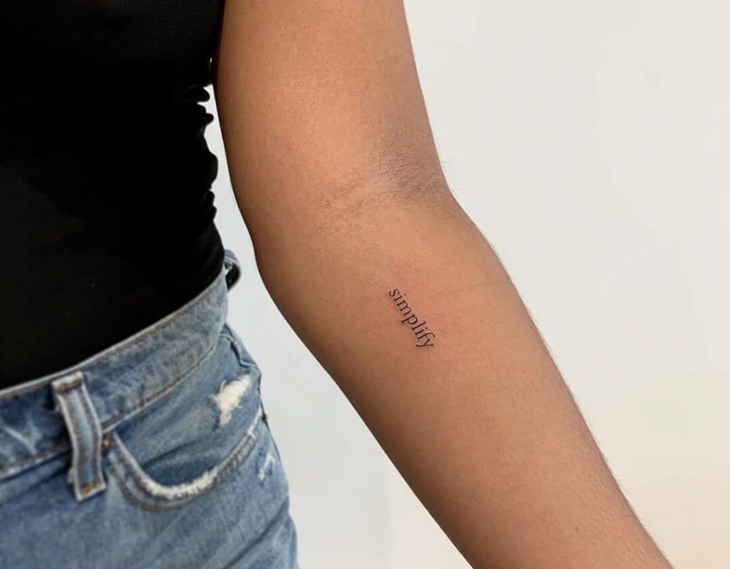 one word tattoo on girl's arm
