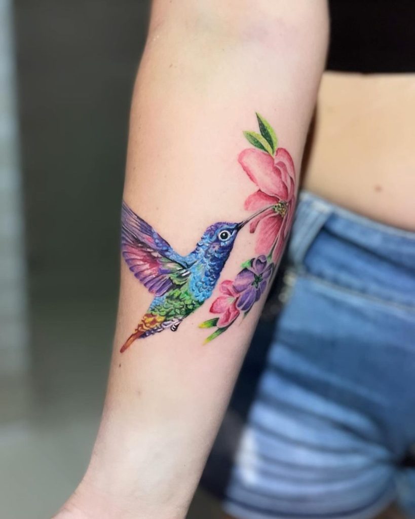 Colorful Painterly Hummingbird and Flowers Tattoo by Andie Ink