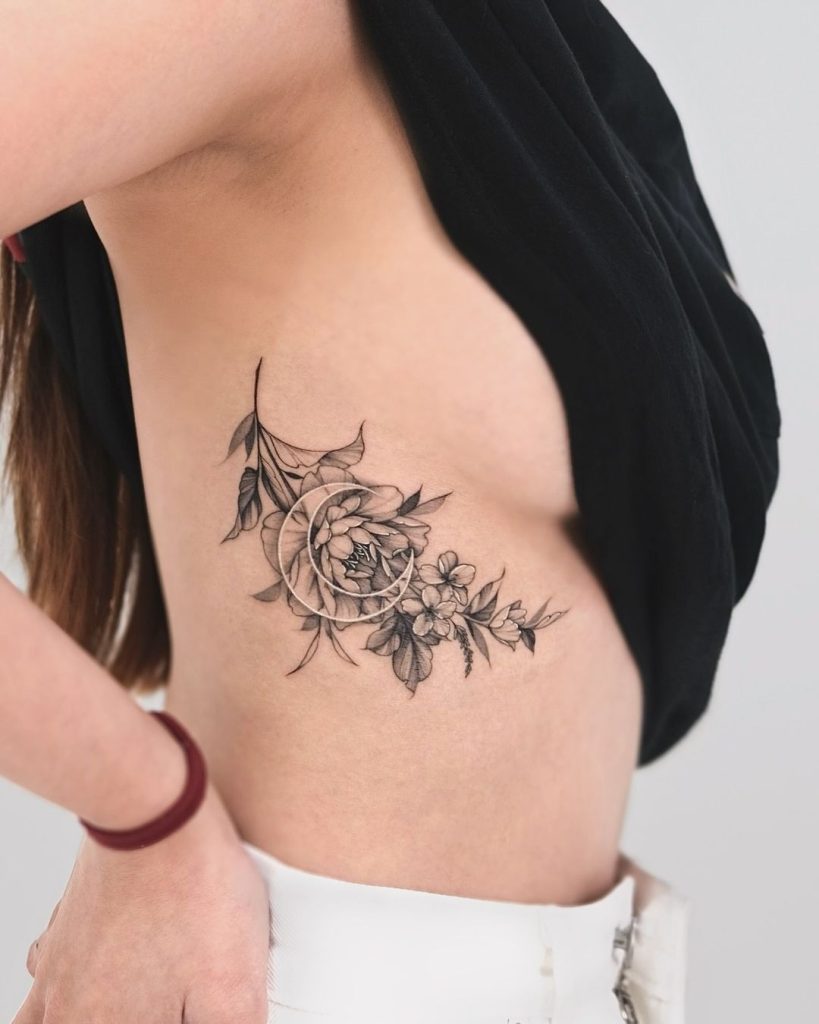 Black and Grey Floral and Moon Rib Tattoo by Hadam