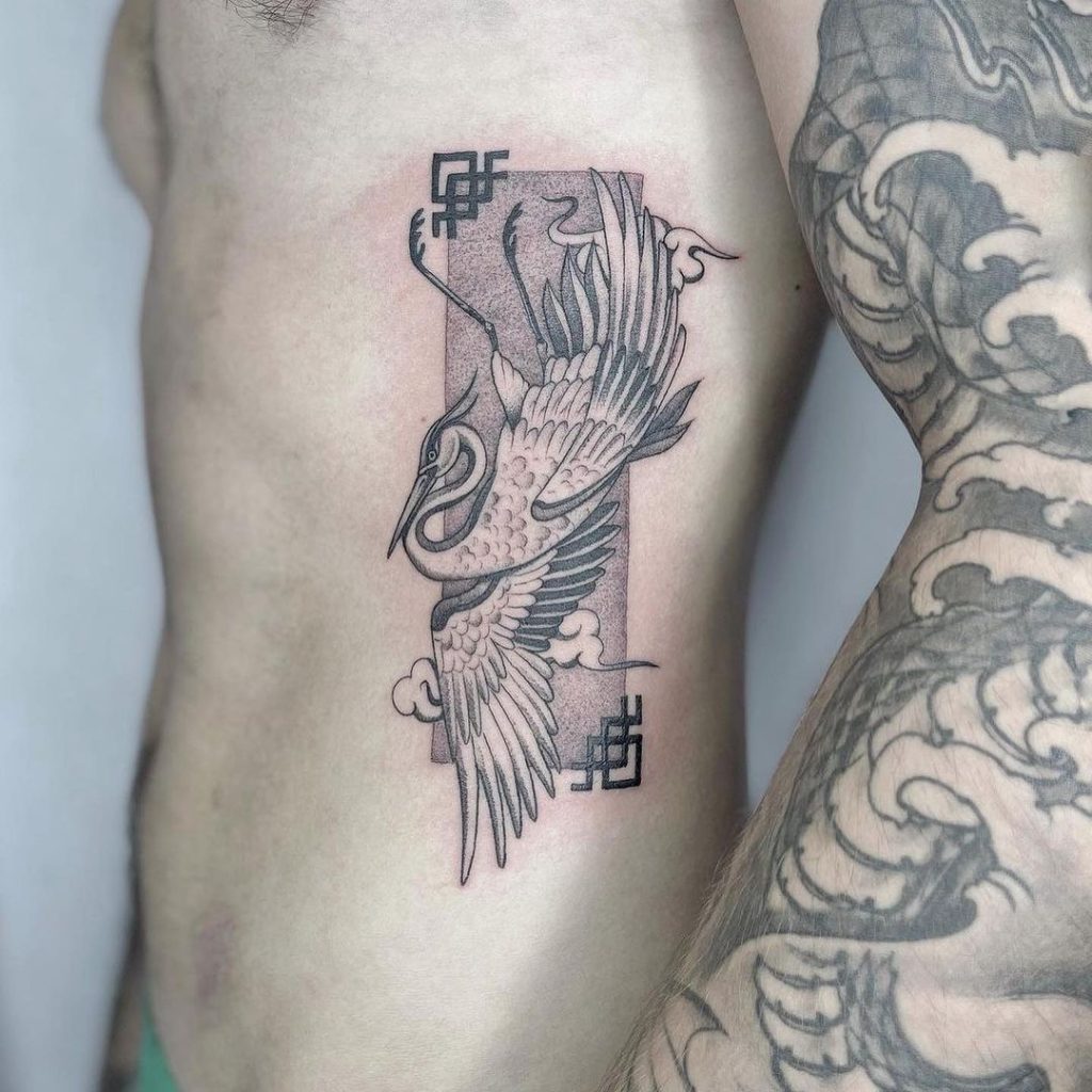 Oriental Heron Rib Tattoo by Tipping Tattoo