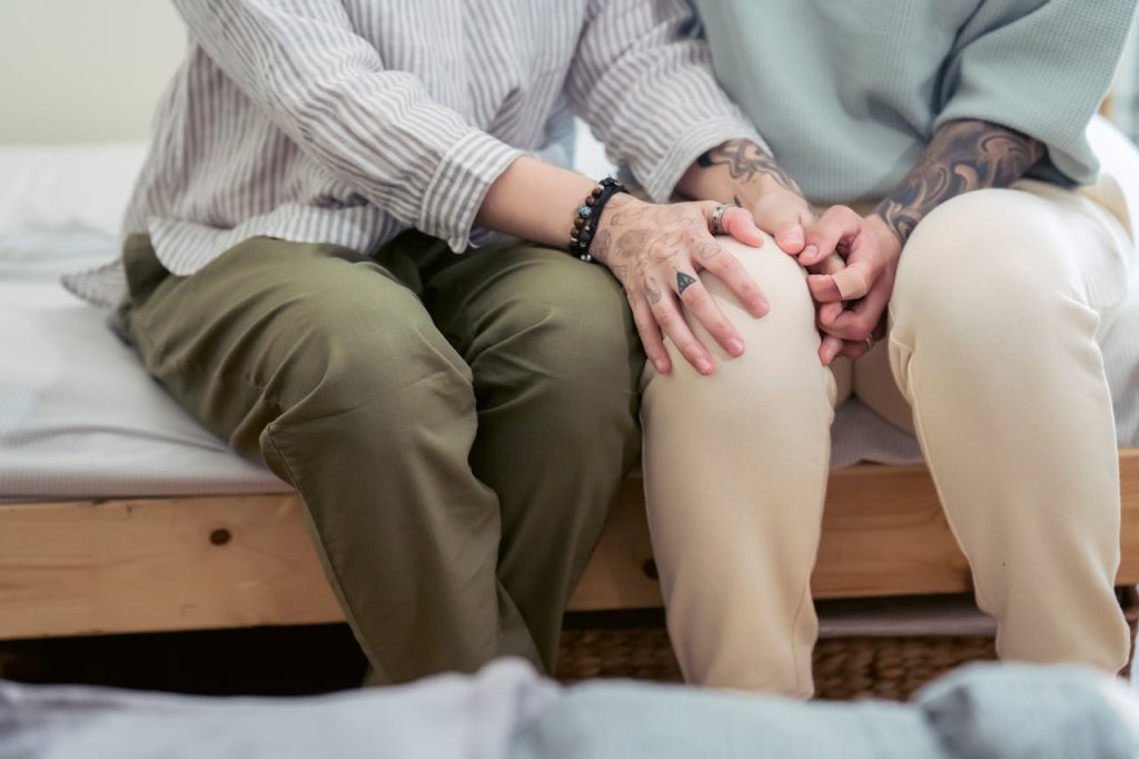 tattooed couple consoling each other