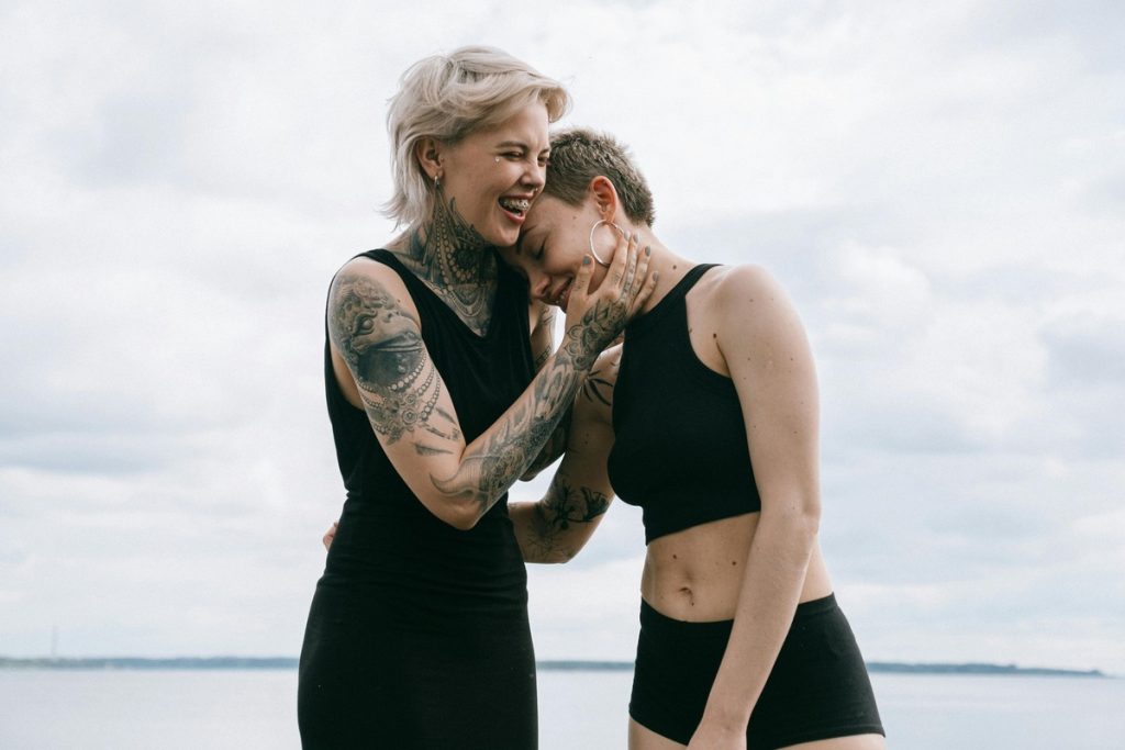 tattooed girl couple on the beach
