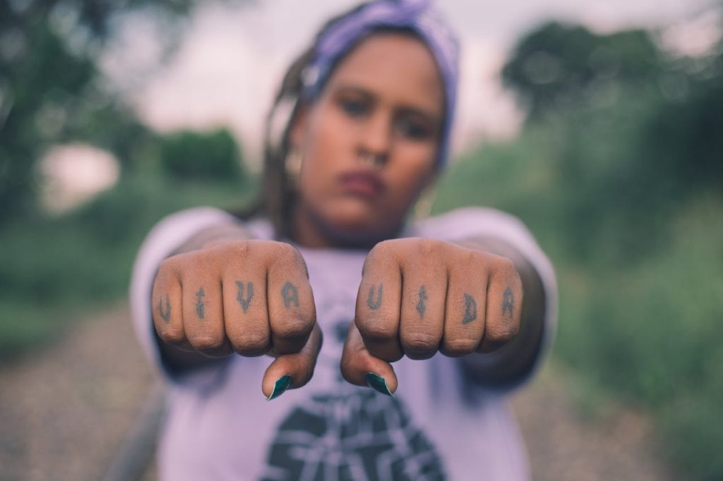 finger tattoos on woman's hands