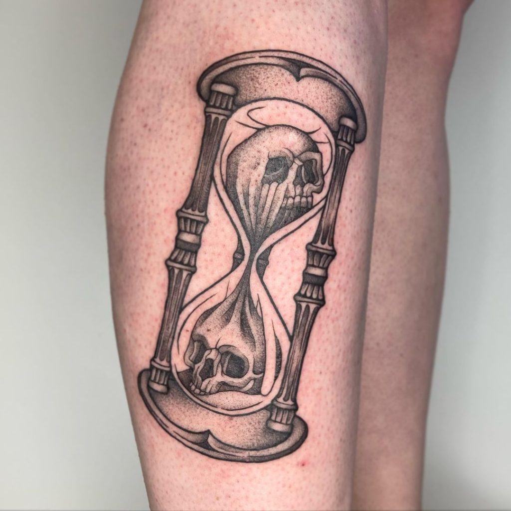 Black and Grey Skulls and Hourglass Tattoo by Spooky