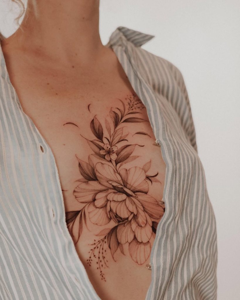 lovely floral chest tattoo in black & grey by Mateus de Assis