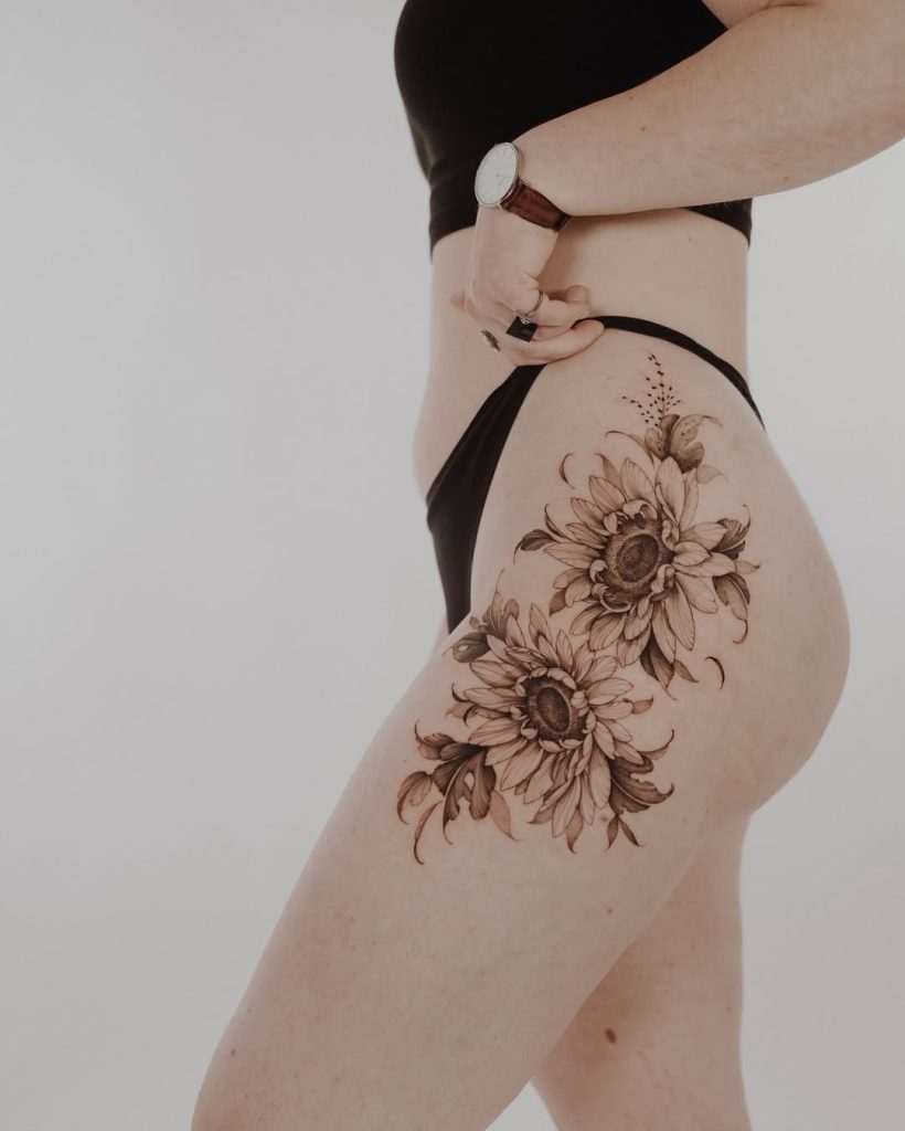 amazing sunflower tattoos in black & grey on the upper tight by Mateus de Assis