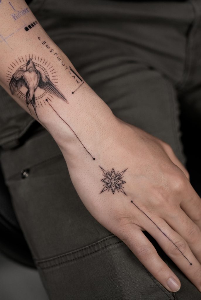 Amazing fineline tattoo of swallow in black & grey