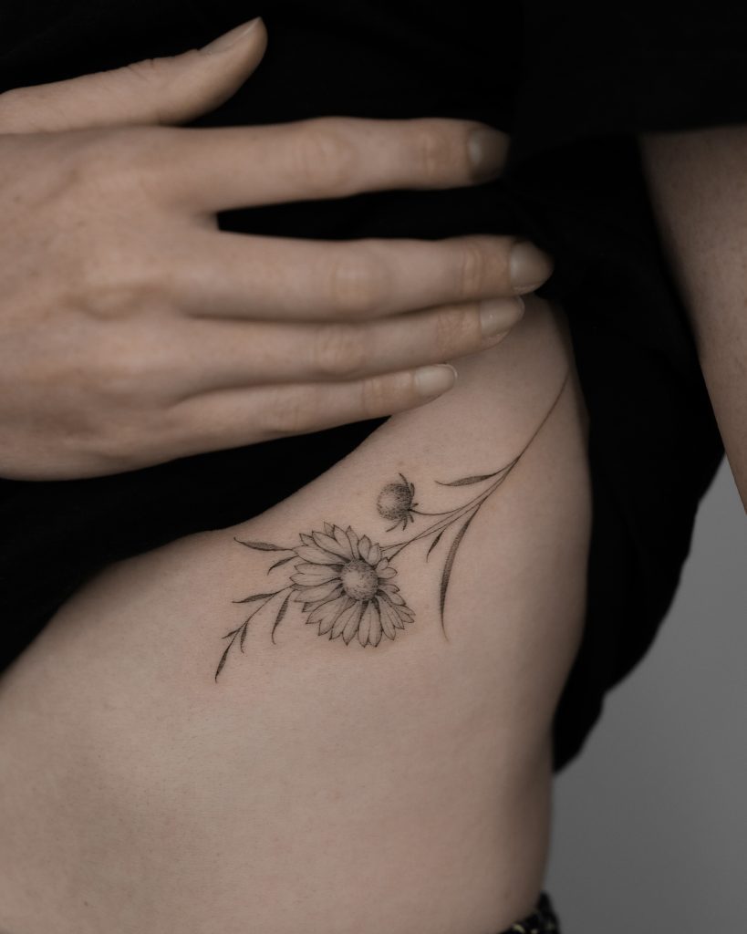 beautiful black & grey daisy flower tattoo by Asya Teryaeva