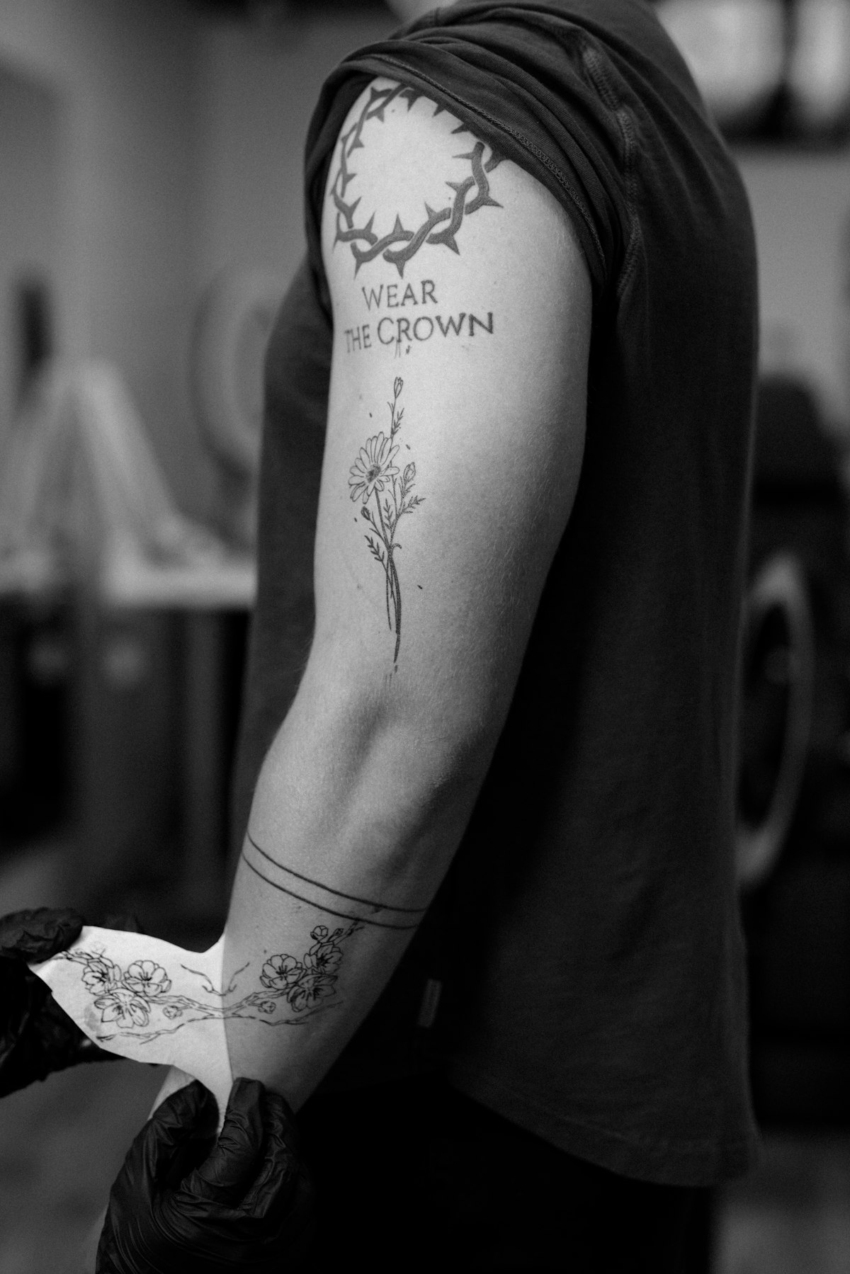 Botanical floral tattoo sleeve on arm showing multiple flower styles
